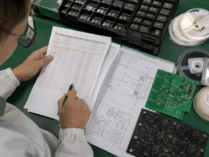 Engineer reviewing BOM and component reels for turnkey PCB assembly planning