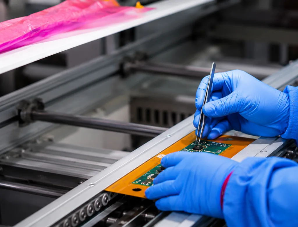 Technician inspecting a PCB assembly for customer support