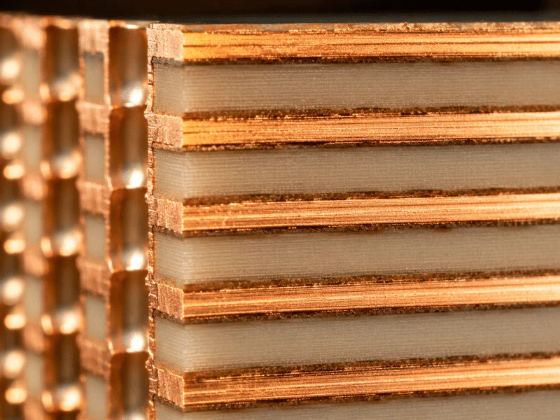 High-frequency PCB material cross-section showing controlled dielectric substrate layers and copper interface for RF signal stability.