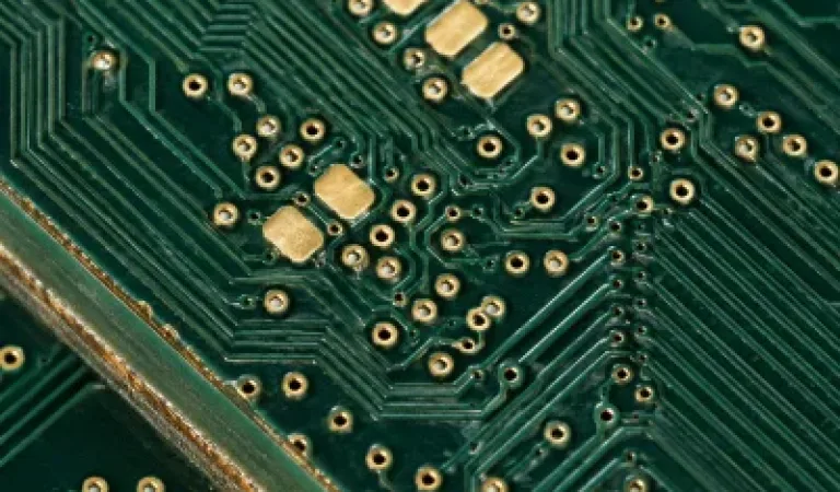 Close-up of FR4 PCB signal traces, small vias, and multilayer edge detail.